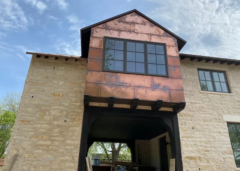 Copper metal panel facade on a stone building for Skylight Installation in Mills River
